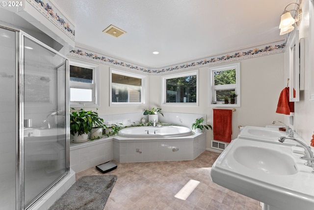 bathroom with sink and separate shower and tub