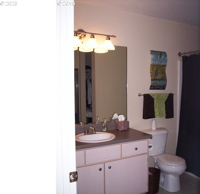 full bathroom with toilet and vanity