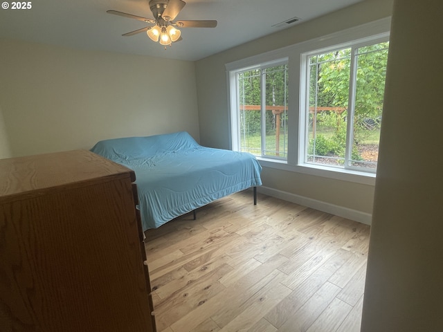 24945 Oak Ln, Elmira, OR 97437 - bedroom with baseboards, wood finished floors, and a ceiling fan