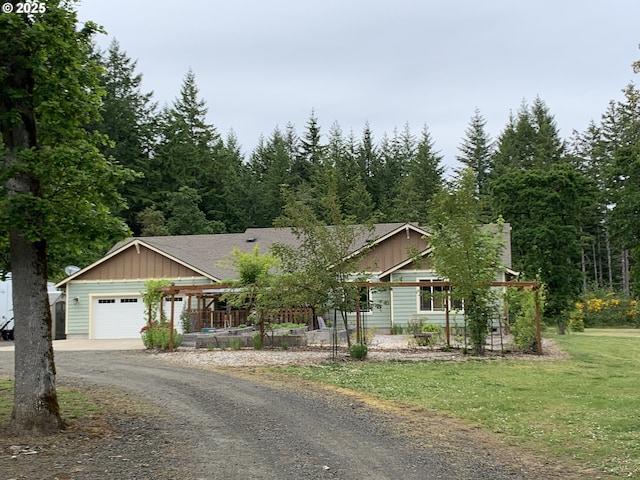 24945 Oak Ln, Elmira, OR 97437 - view of front of property with an attached garage, dirt driveway, a front yard, and board and batten siding