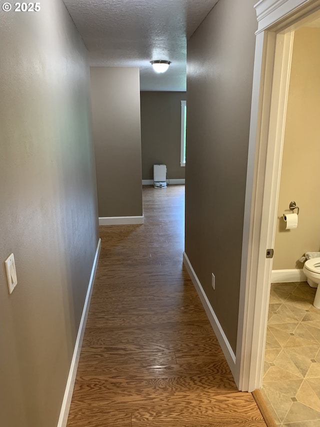 24945 Oak Ln, Elmira, OR 97437 - corridor featuring baseboards, light wood-style flooring, and a textured ceiling