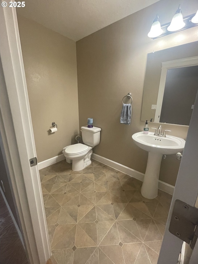 24945 Oak Ln, Elmira, OR 97437 - bathroom featuring toilet and baseboards