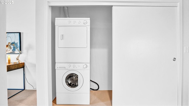 laundry room featuring stacked washer and clothes dryer