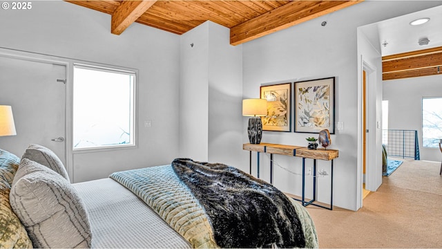 bedroom with wood ceiling, light colored carpet, and beamed ceiling