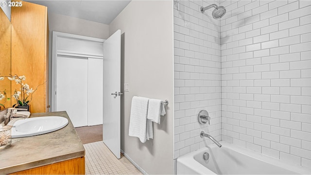 bathroom featuring vanity, tile patterned floors, and tiled shower / bath