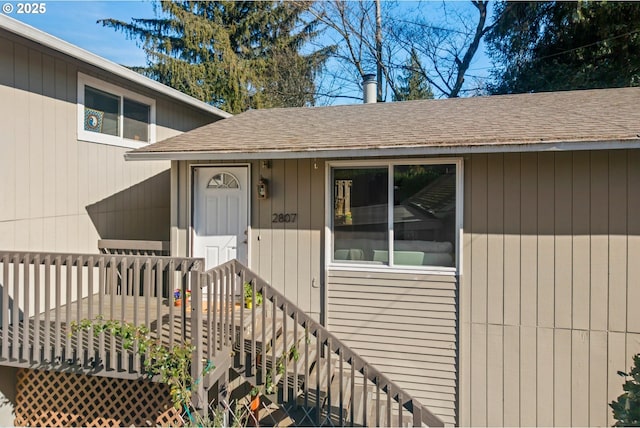 property entrance with a shingled roof