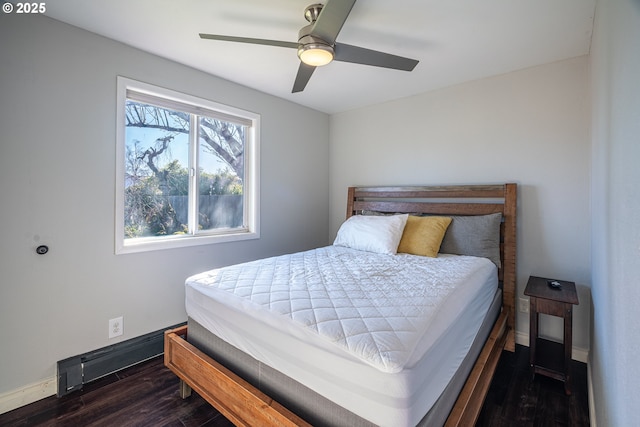 bedroom featuring a ceiling fan, baseboards, and dark wood-style flooring