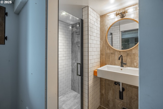 full bath featuring a stall shower and tile walls