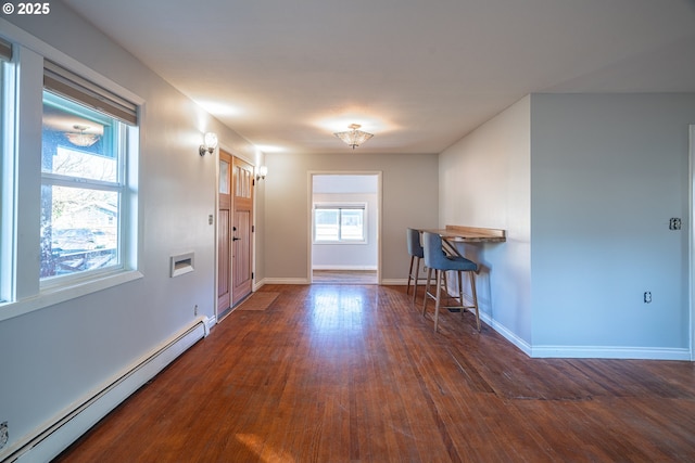 entryway featuring baseboards, baseboard heating, and hardwood / wood-style floors