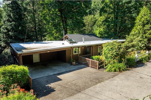 view of front of house with a carport and concrete driveway