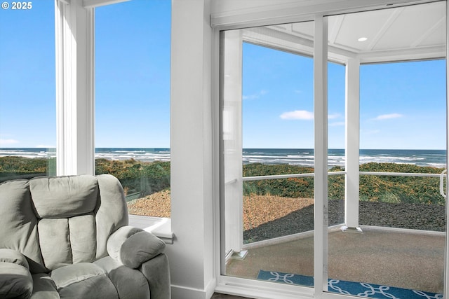 sunroom featuring a healthy amount of sunlight and a water view