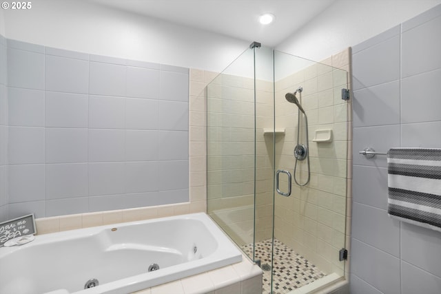 full bathroom featuring a stall shower, a jetted tub, and recessed lighting