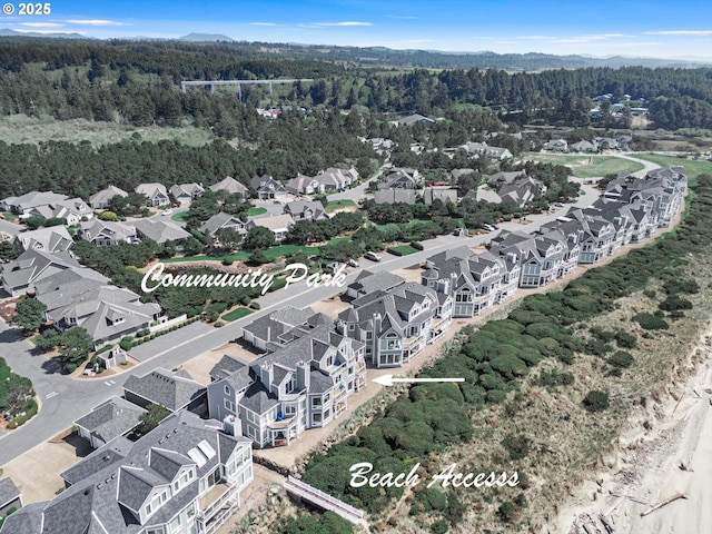 drone / aerial view with a residential view and a forest view