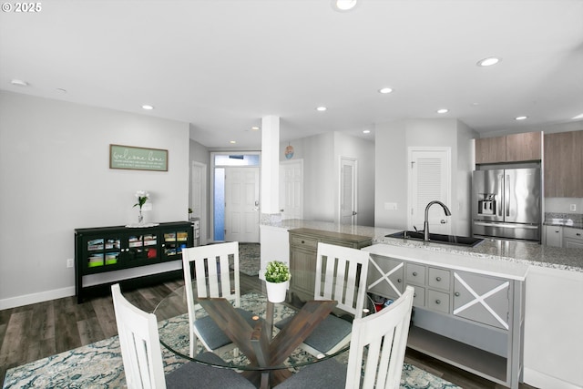 dining space with recessed lighting, baseboards, and dark wood finished floors