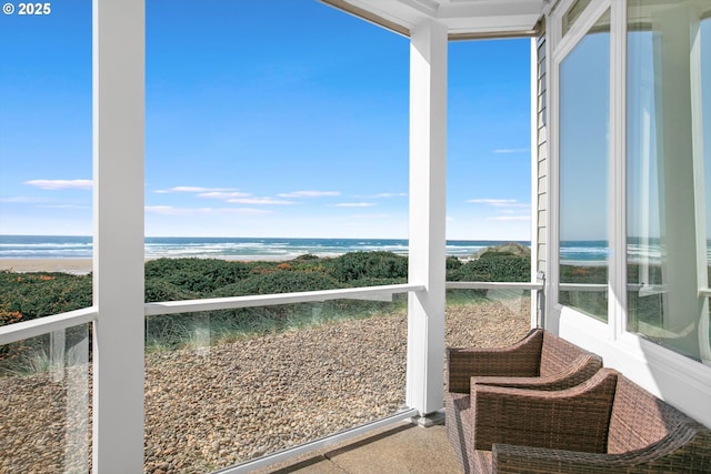unfurnished sunroom featuring a water view