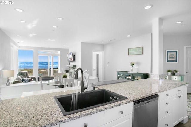 kitchen featuring white cabinets, recessed lighting, dishwasher, and a sink