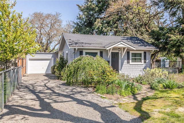 9305 SE Mill St, Portland, OR 97216 - view of front of home with roof with shingles, driveway, and fence