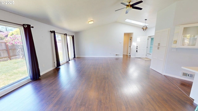 335 Mill Beach Rd, Brookings, OR 97415 - unfurnished living room with ceiling fan, plenty of natural light, dark wood finished floors, vaulted ceiling, and baseboards