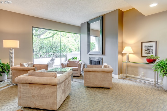 living room with healthy amount of natural light, a high end fireplace, baseboards, and a textured ceiling