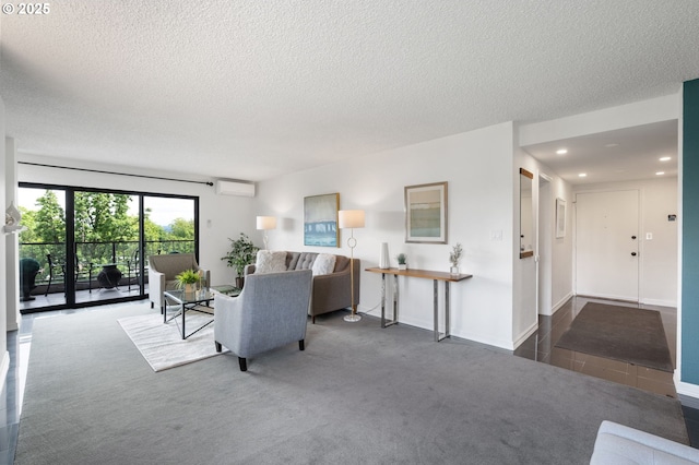 carpeted living area with a wall unit AC, a textured ceiling, and recessed lighting