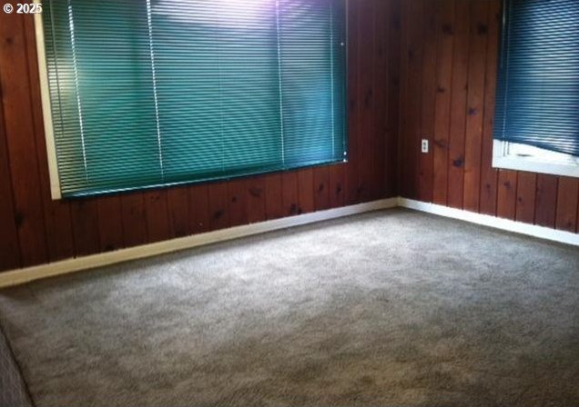 2260 D St, Springfield, OR 97477 - carpeted spare room with baseboards and wood walls