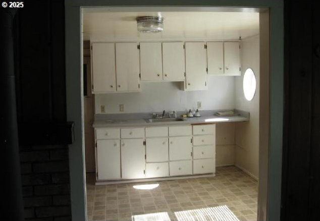 2260 D St, Springfield, OR 97477 - kitchen featuring white cabinets and light countertops