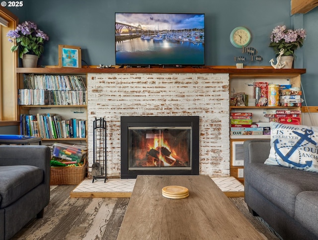 5353 SW Neal Ave, Waldport, OR 97394 - living area featuring wood finished floors and a brick fireplace