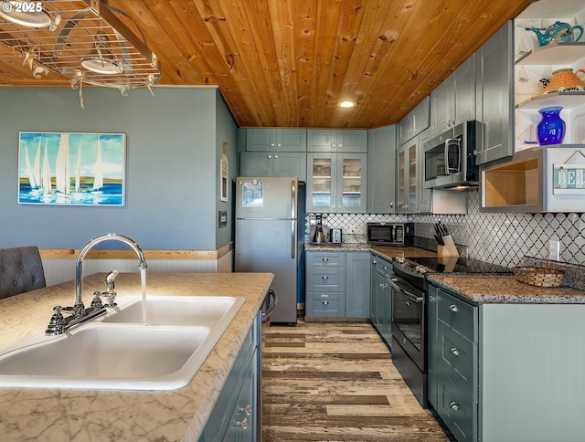5353 SW Neal Ave, Waldport, OR 97394 - kitchen featuring stainless steel appliances, light wood finished floors, open shelves, wood ceiling, and backsplash
