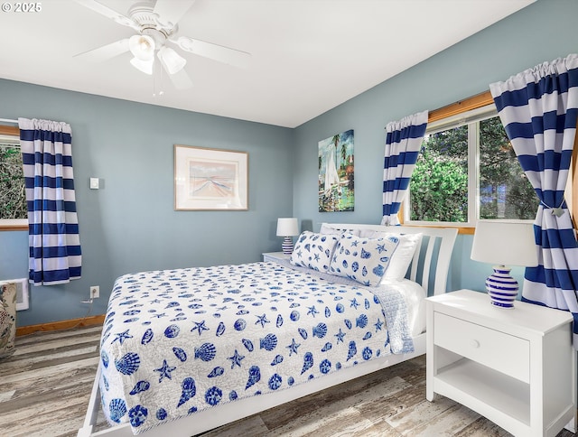 5353 SW Neal Ave, Waldport, OR 97394 - bedroom with wood finished floors and ceiling fan