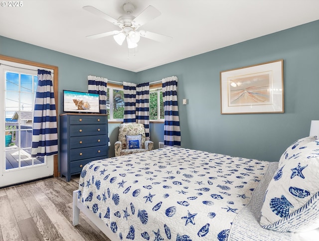 5353 SW Neal Ave, Waldport, OR 97394 - bedroom featuring wood finished floors, multiple windows, and a ceiling fan