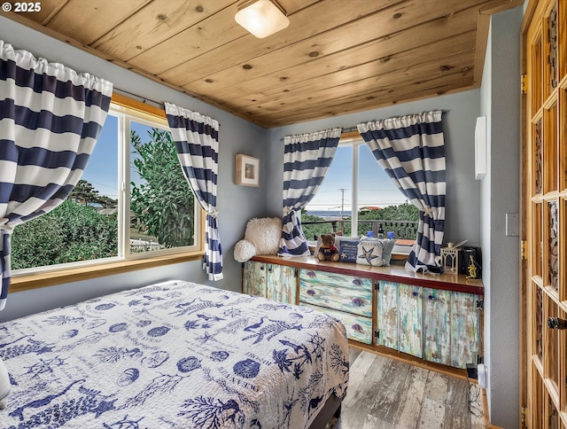 5353 SW Neal Ave, Waldport, OR 97394 - bedroom featuring multiple windows, hardwood / wood-style floors, and wooden ceiling