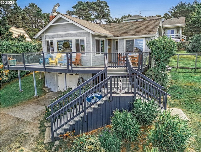 5353 SW Neal Ave, Waldport, OR 97394 - view of front of home with stairs, a chimney, a front lawn, and a garage