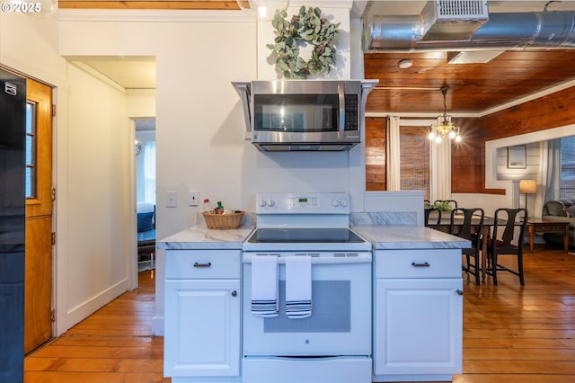 kitchen with white cabinetry, white range with electric stovetop, stainless steel microwave, and decorative light fixtures