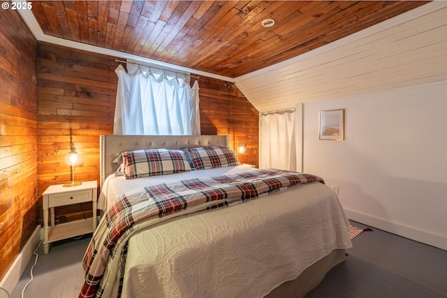 bedroom with vaulted ceiling, wooden walls, wood finished floors, wooden ceiling, and baseboards