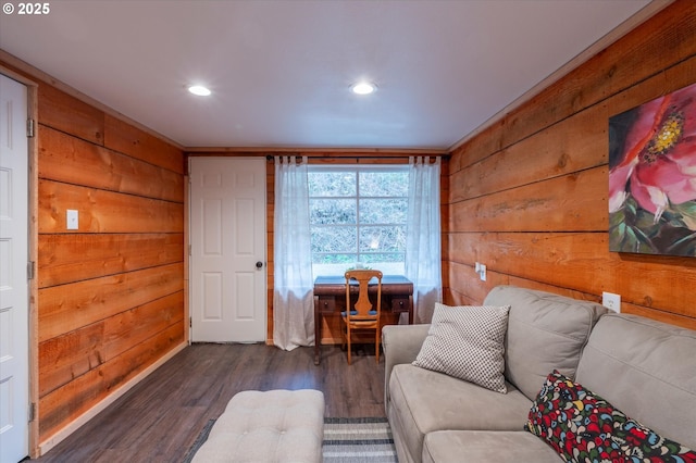 living room featuring dark wood-style floors, recessed lighting, and wood walls