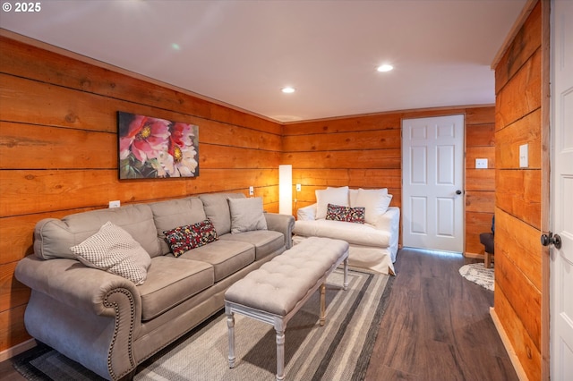 living room featuring wooden walls, dark wood finished floors, and recessed lighting