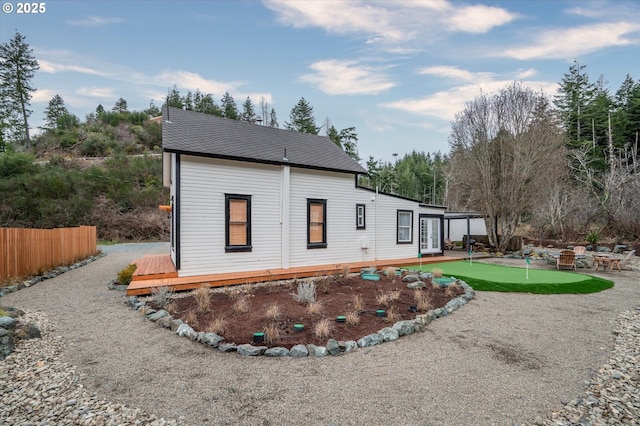 back of house featuring fence