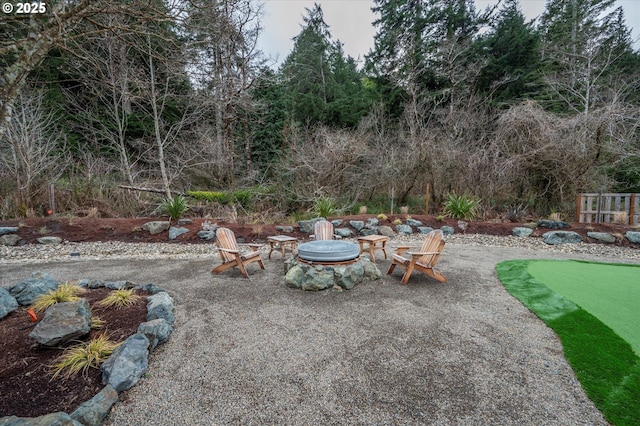 view of yard with an outdoor fire pit