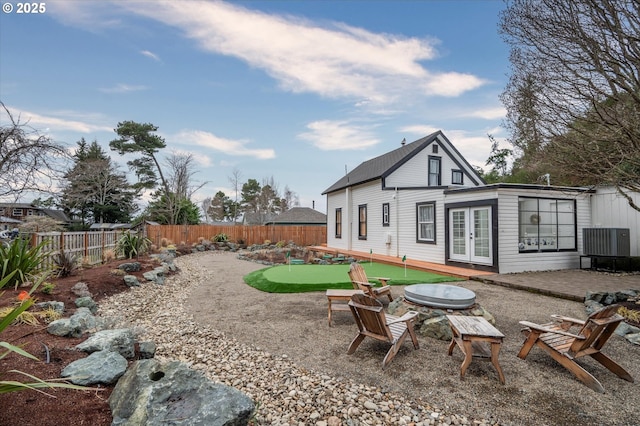 back of property featuring a fenced backyard, a patio, and french doors