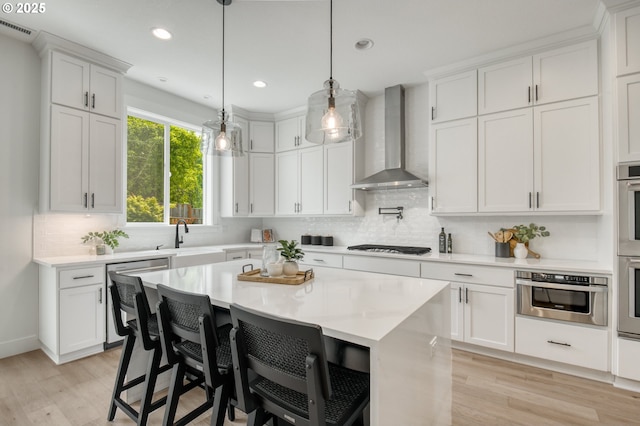 11723 NW Sadie St, Portland, OR 97229 - kitchen featuring wall chimney range hood, a sink, light wood-type flooring, light countertops, and recessed lighting