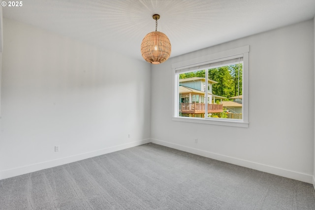11723 NW Sadie St, Portland, OR 97229 - empty room featuring carpet, a chandelier, and baseboards