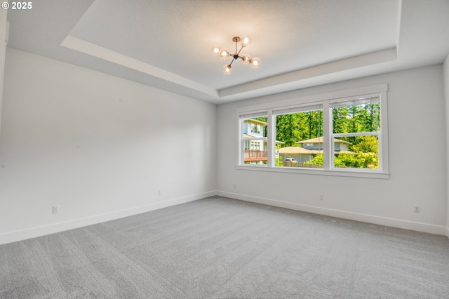 11723 NW Sadie St, Portland, OR 97229 - spare room featuring a raised ceiling, a chandelier, light carpet, and baseboards