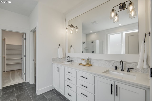 11723 NW Sadie St, Portland, OR 97229 - bathroom with a shower stall, double vanity, baseboards, and a walk in closet