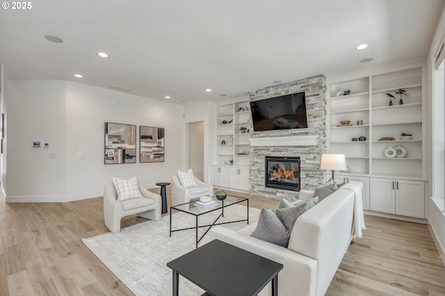 11723 NW Sadie St, Portland, OR 97229 - living area featuring light wood finished floors, baseboards, a stone fireplace, recessed lighting, and built in features