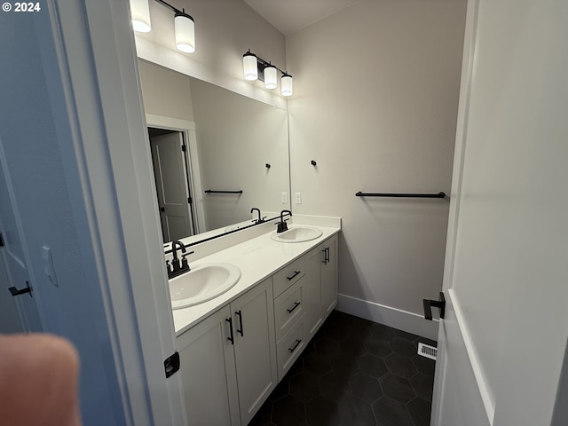 bathroom with tile patterned flooring and vanity