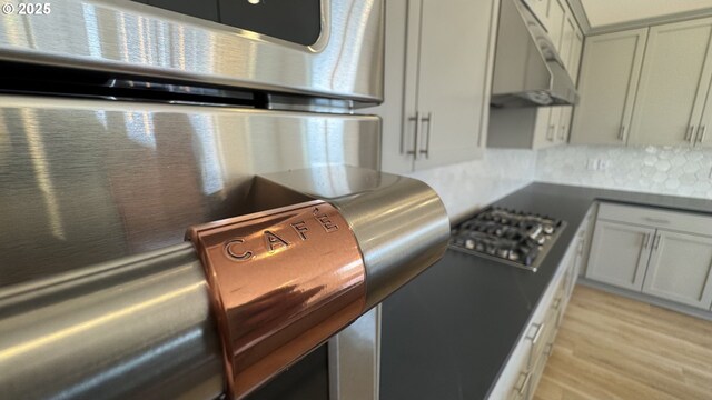 11699 SW 178th Dr, Beaverton, OR 97007 - kitchen featuring ventilation hood, dark countertops, appliances with stainless steel finishes, backsplash, and white cabinets
