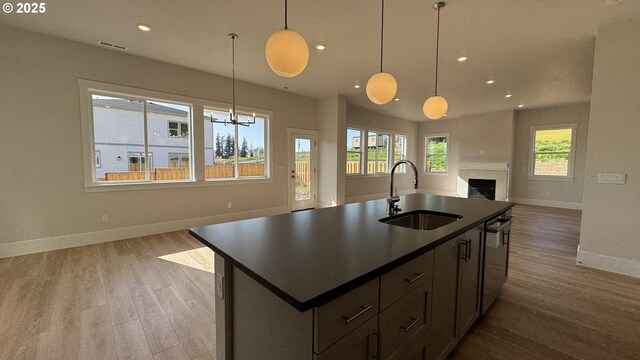 11699 SW 178th Dr, Beaverton, OR 97007 - kitchen with under cabinet range hood, dark countertops, stainless steel double oven, gas cooktop, and decorative backsplash
