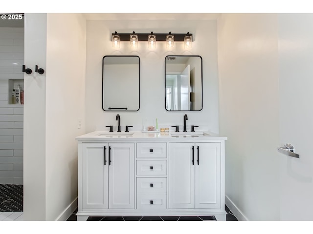full bathroom with double vanity, baseboards, and a sink