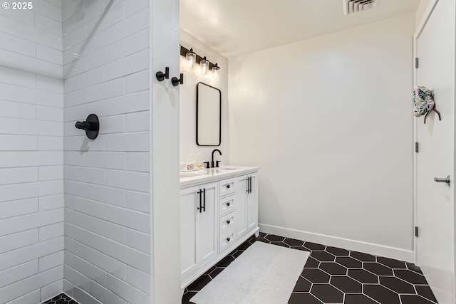 1255 NW 9th Ave Unit 806, Portland, OR 97209 - full bathroom featuring visible vents, vanity, baseboards, tile patterned floors, and tiled shower