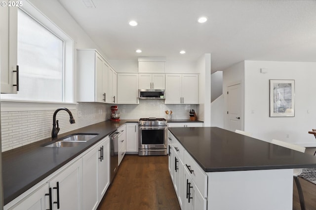 14878 NW Olive St, Portland, OR 97229 - kitchen featuring a sink, appliances with stainless steel finishes, backsplash, and dark countertops